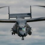 black helicopter carrier hovering on sky