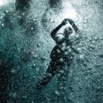 A person swimming in the water with bubbles